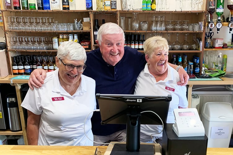 Happy barman Alan Moore with club coaches - his wife Janet and Angela Moore