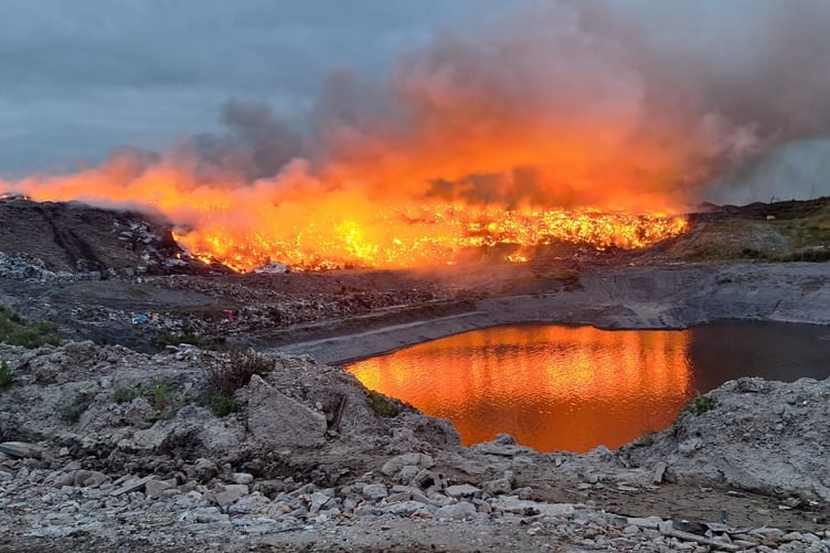 Fire fighters fought to contain the flames as they spread across the more than 2-acre site