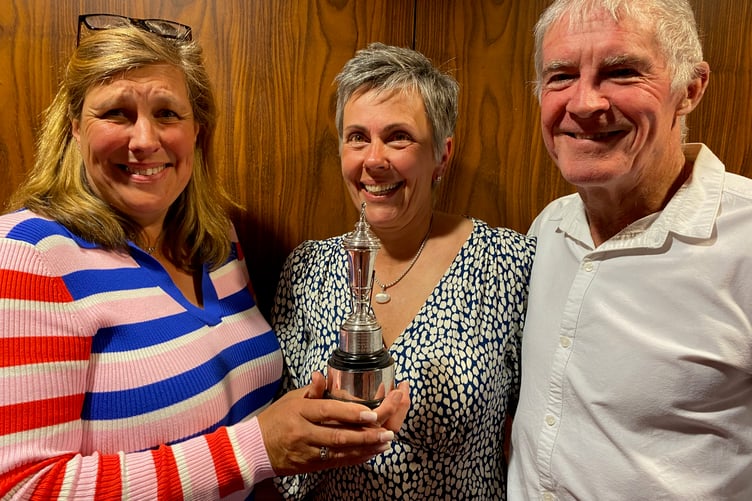 Helen White, mixed golf organiser, presents the Jack King Trophy to Amanda and Angus Mather