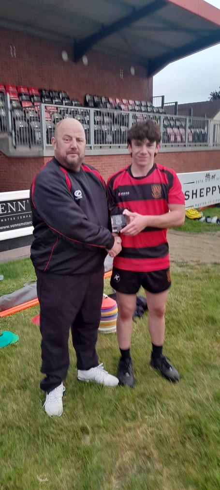 Bailey Lee is presented with the Most Improved Player award for last season by Mark Allder