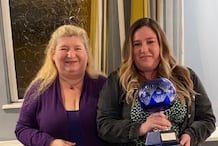 Ali Stubbings, secretary, presents the singles trophy to Ellie Stubbings of Divas. Ellie also won the triples, doubles and mixed pairs.