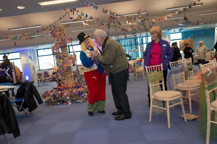 Reminiscence Learning chief executive Fiona Mahoney as 'Archie' preparing for a dementia session.