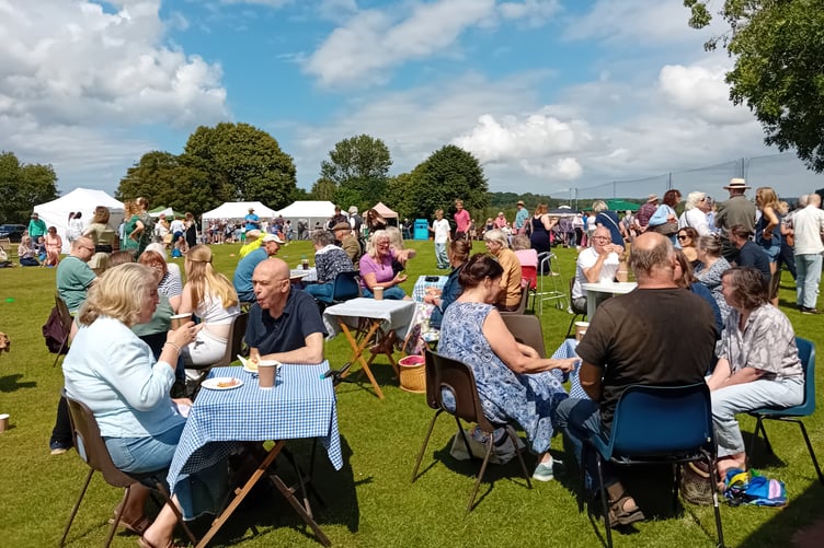 Visitors and local residents enjoy tea and homemade cakes on the village cricket ground in Fitzhead fete