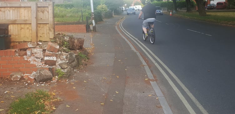 The garden wall destroyed when three cars were involved in a collision in Longforth Road, Wellington, on Saturday night.