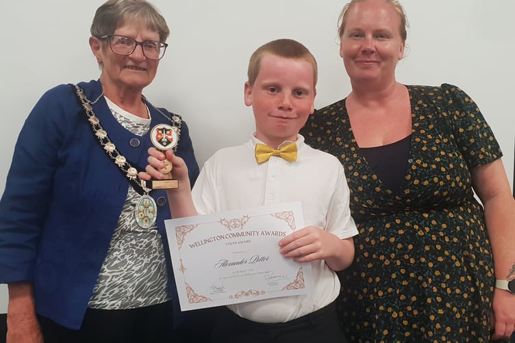 Alex Potter with his Wellington Town Council community award for his litter picking exploits, pictured with his mother Abbey and Mayor Cllr Janet Lloyd.