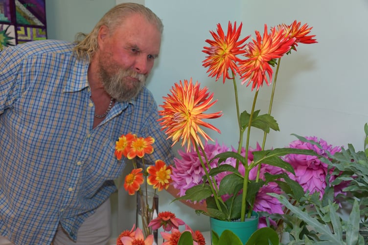 Nynehead Garden Club vice-chairman Bob Foster admires entries in this year's village flower show.