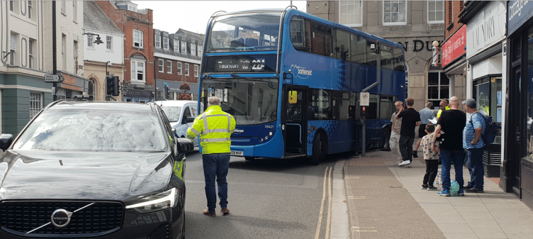 A double deck bus became stuck on railings in Wellington town centre.