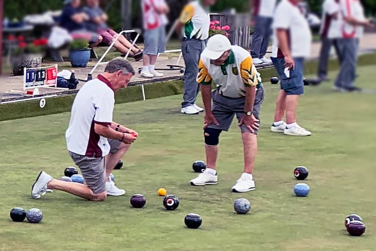 Wellington's Dave Beaudet measures to see which bowl is closest the jack
