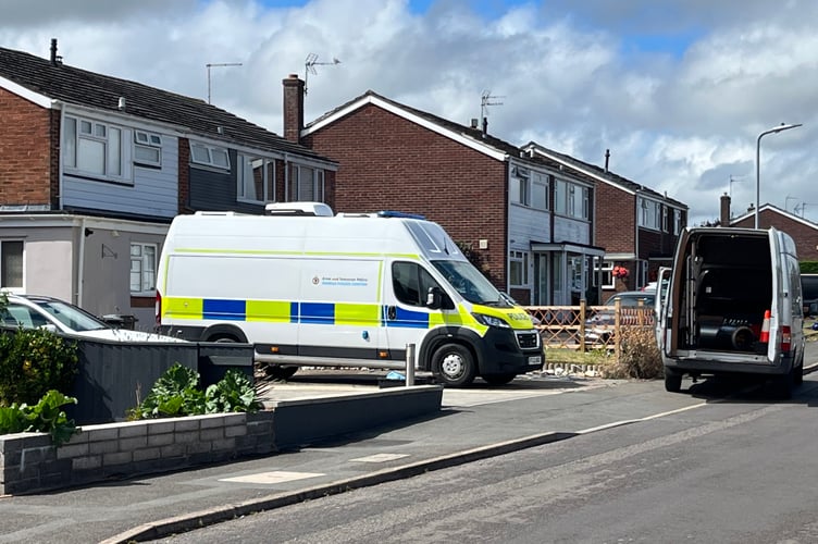 Police vehicles outside a property in Sylvan Road