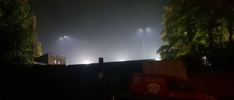 Wellington Football Club's existing floodlights in use for a match, viewed from North Street.