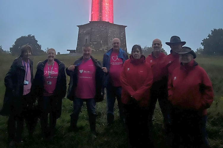 Pictured (left to right): NHS colleagues and National Trust volunteers as the Wellington Monument turns pink (Photo: Somerset NHS Foundation Trust)