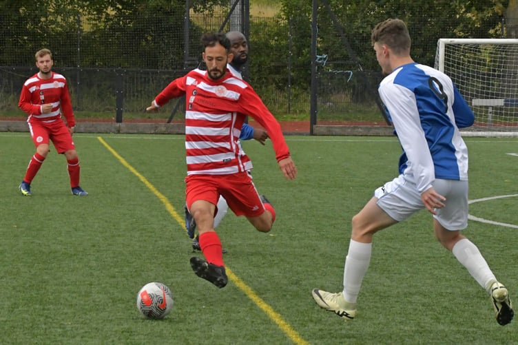 Bradski Holmans on the ball for Moortown with Cameron Perry-Jones in the background.