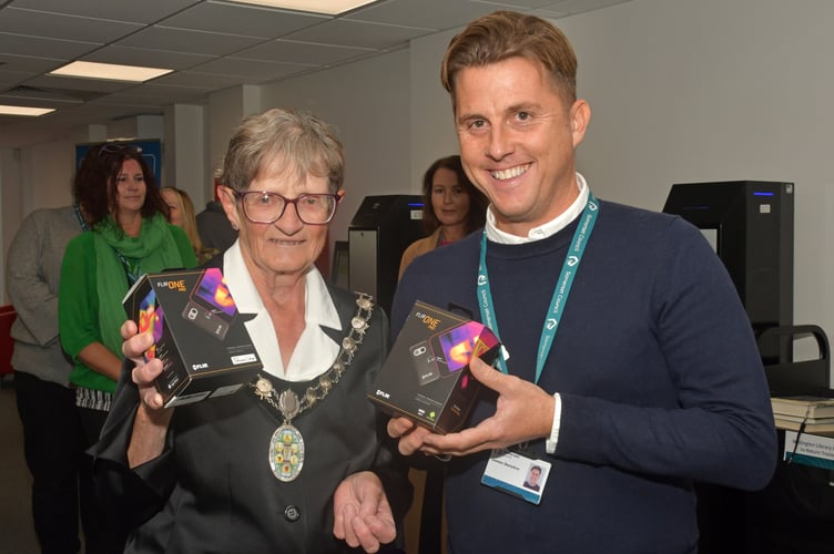The Mayor of Wellington, Councillor Janet Lloyd, presenting the new thermal imaging cameras to Wellington Library Supervisor, James Denslow (Photo: Alain Lockyer)
