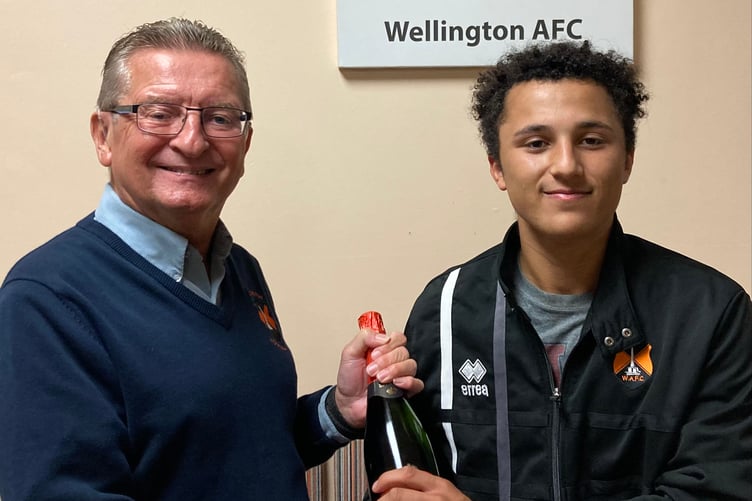 Wellington's Man of the Match Phil Mendonca is presented with his award by the club's media manager Ken Bird
