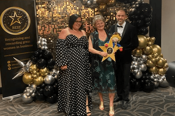 Reminiscence Learning chief executive Fiona Mahoney (centre) receives her  Best Businesswomen Award from PA and business manager Zoe Priestley and creative development manager Shane Mace.