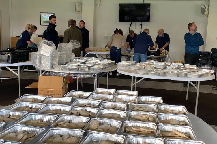 Volunteers from Thomas Franks, Somerset County Cricket Club and City Harvest package meals for those in need