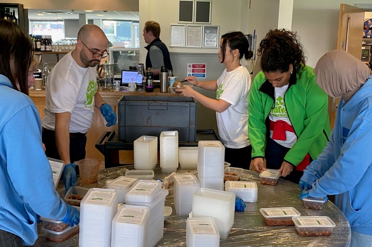 Volunteers from Thomas Franks, Somerset County Cricket Club and City Harvest package meals for those in need