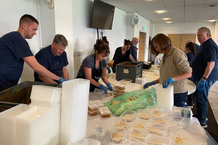 Volunteers from Thomas Franks, Somerset County Cricket Club and City Harvest package meals for those in need