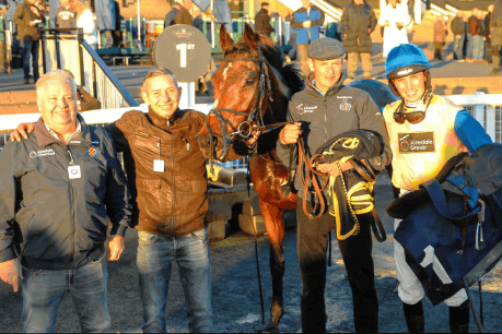 Chemical Warfare in the winners enclosure at Newcastle with jockey Harry Cobden and winning connections