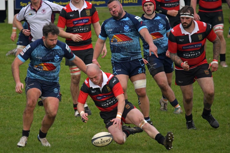 Ollie Price drops on the ball under pressure in the match against Tiverton