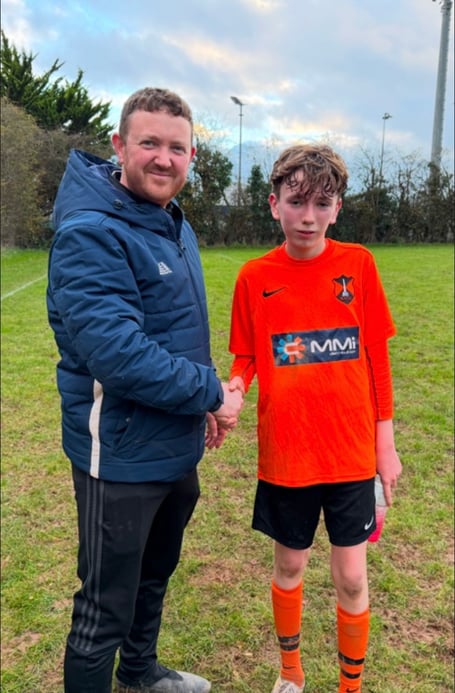 Wellington Town U14 coach Darren Winter with Player of the Match Sam Alderman