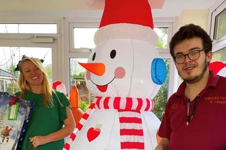 Manager Zillah Oakes and activities team member Michael Rowe receiving Dunelm gifts.jpg