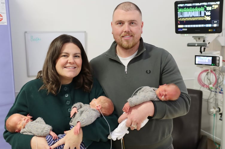 Mum and dad Stacey and Grant with their triplets
