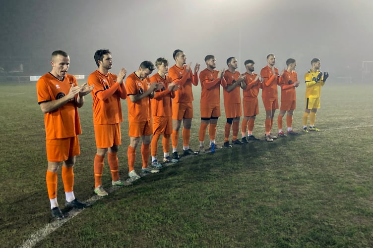 Wellington players hold a minute’s applause for Norman Rogers whose funeral takes place at Taunton Deane Crematorium on Friday, January 31 (2p.m.).