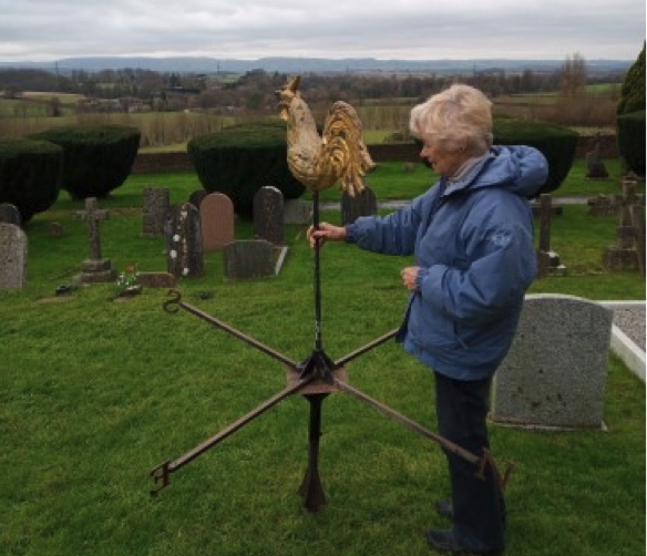 The Vicar of Langford Budville, the Rev Helene Stainer, with the parish church's fallen cockerel weather vane.