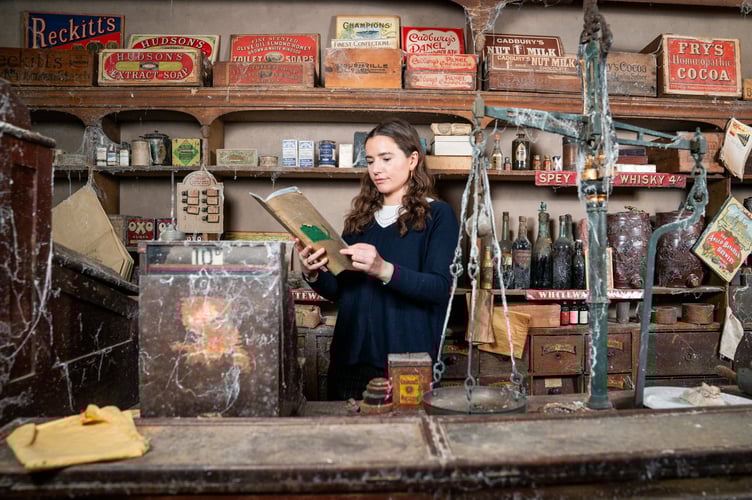 Auctioneer Carolin Lay reads a document in Victorian pharmacy that was uncovered in Somerset, after being boarded up more than 100 years ago and has been kept exactly the same, before it gets sold next month from Flambards Cornwall. February 20 2025. A former theme park is auctioning nearly 1500 items - including an entire Victorian 'time capsule' village. Assets from 50 shops in the unique village and Britain and the Blitz exhibits at Flambards are going under the hammer next month after the closure after the popular Cornish attraction. After almost 50 years, rising costs and falling visitor numbers forced the attraction to shut its doors in November last year. Lay's Auctioneers have now announced a special sale of its assets which includes the historic shops that have taken visitors back in time for decades.  A spokesperon for the auctioneers said: âThe auction will encompass all 50 astonishingly detailed shops in the Victorian Village, the similarly remarkable âBritain in the Blitzâ installation, and the surrounding war galleries. âAll the supporting historical displays, including the full-size Concorde and the Avro Shackleton Cockpit."
