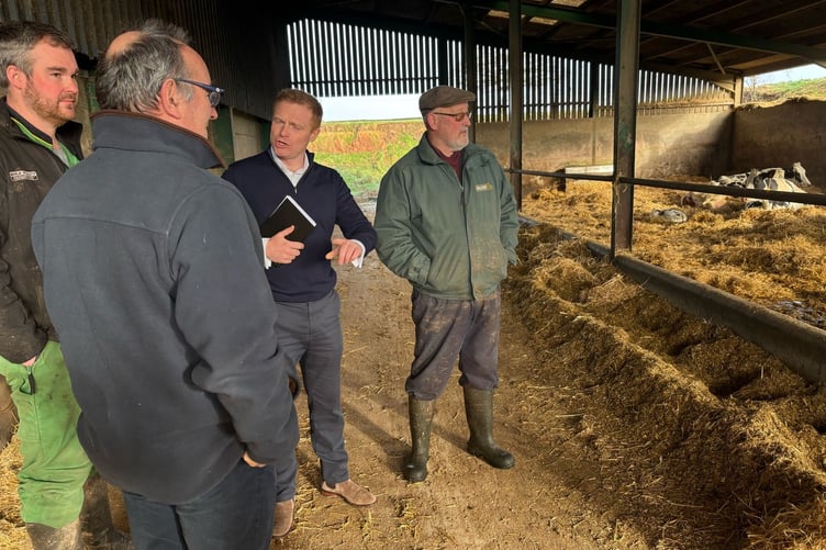Shadow farming Minister Robbie Moore (centre) meets farmers David and Luke Partridge.