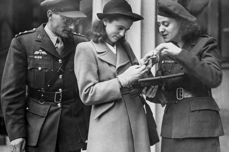 Photograph of Odette having just received her George Cross, 1946, pictured with her daughter, Francoise, and Peter Churchill