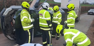 Driver rescued after vehicle towing animal trailer overturns