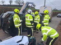 Driver rescued after vehicle towing animal trailer overturns