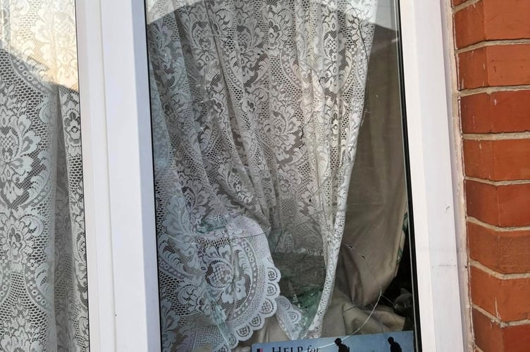 The smashed downstairs window at Brian's home in Wellington