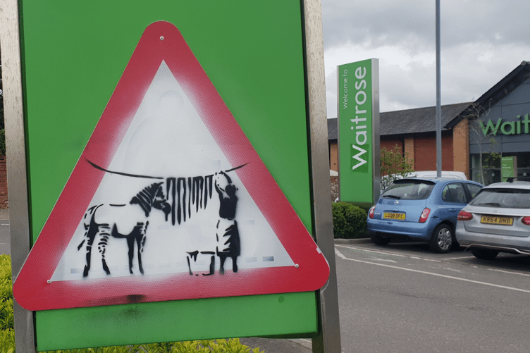 A close-up of a painting which is attracting attention in the car park of Wellington's Waitrose supermarket.