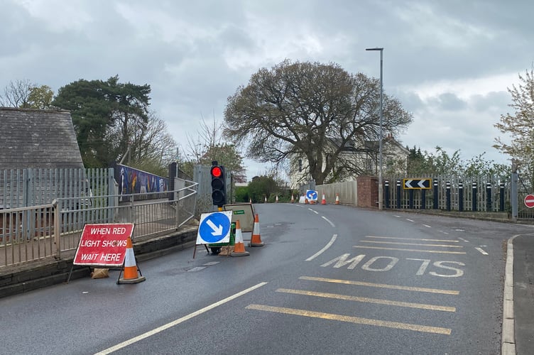 Temporary traffic lights are in place on Milverton Road after a vehicle knocked a wall onto the railway tracks below Tonedale bridge
