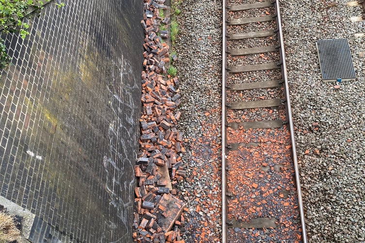 The debris has now been cleared from the tracks below Tondedale bridge after a traffic accident led to a wall being knocked to onto the line below
