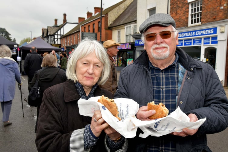 STUART AND MARIANNE GIFFORD ENJOYING AND PASTIE AT THE STREET FAIR