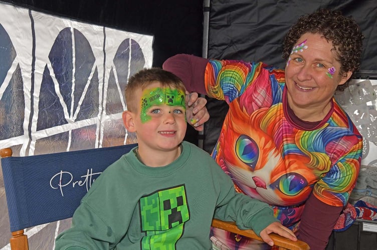 YOUNG BENJIMAN  MILLEHAM ENJOYING HIS FACE PAINT FROM JEN DINHAM [RIGHT]