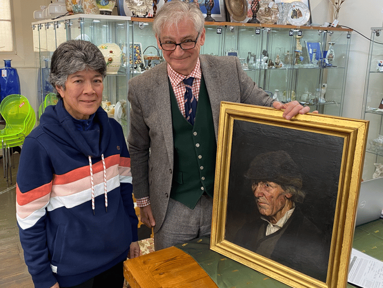 Cristian Beadman and Vida Jackson pose with Vida's oil on canvas which has been taken for further professional evaluation