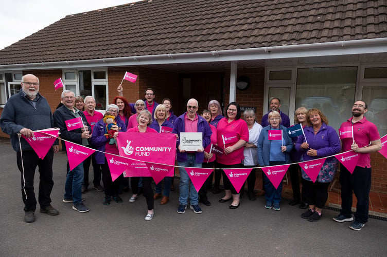Reminiscence Learning chief executive Fiona Mahoney (front) with staff and supporters celebrating the charity's National Lottery grant.