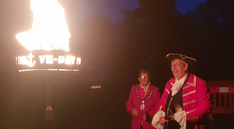 Wellington Mayor Cllr Janet Lloyd accompanied by town crier Andrew Norris lit a VE Day 80th anniversary beacon in Wellington Park.