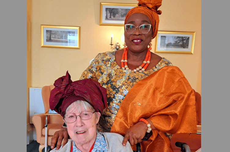 Justina with resident, Tina – trying on headwear.