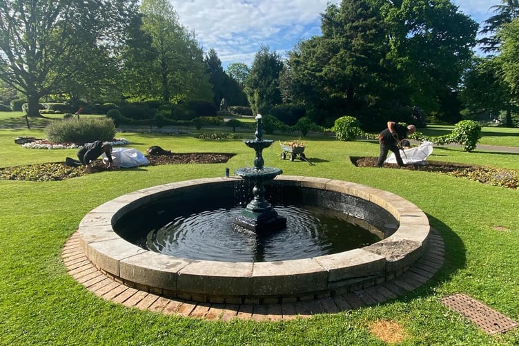 Wellington Park's fountain with town council open spaces team members Jay Prosser and Alan Wilson prepare summer displays. PHOTO: WTC.
