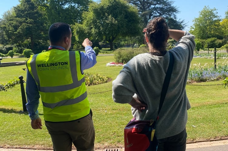 Town council open spaces manager Darren Hill shows Green Flag judges around Wellington Park. PHOTO: WTC.
