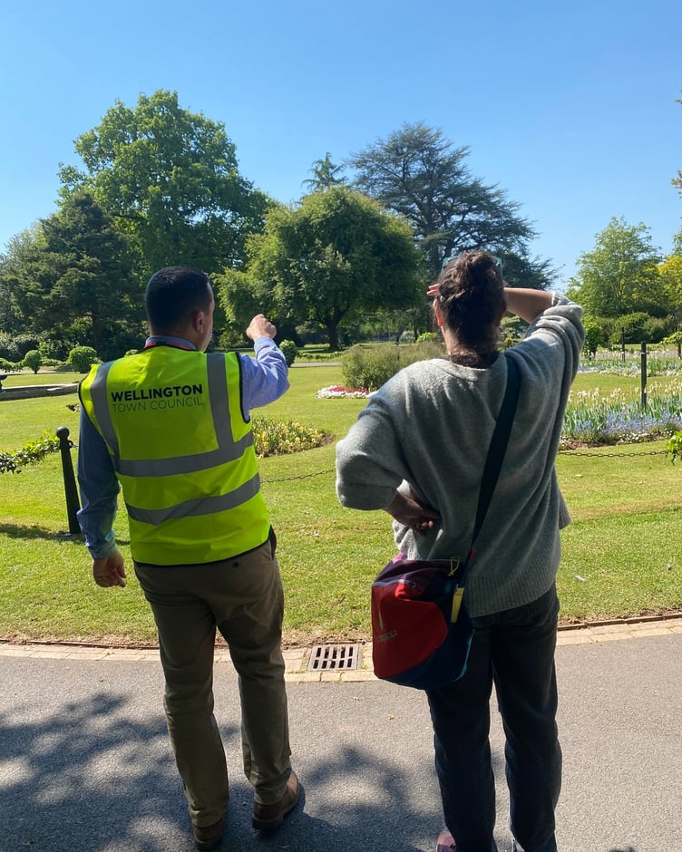 Town council open spaces manager Darren Hill shows Green Flag judges around Wellington Park. PHOTO: WTC.