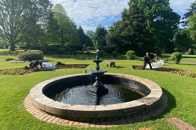 Wellington Park's fountain with town council open spaces team members Jay Prosser and Alan Wilson prepare summer displays. PHOTO: WTC.