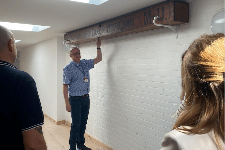 Town council community connect champion Peter Joint points out an historic box inscribed by the now-defunct Wellington Lodge of Oddfellows which is being kept in the Kings Arms community hub. PHOTO: WTC.