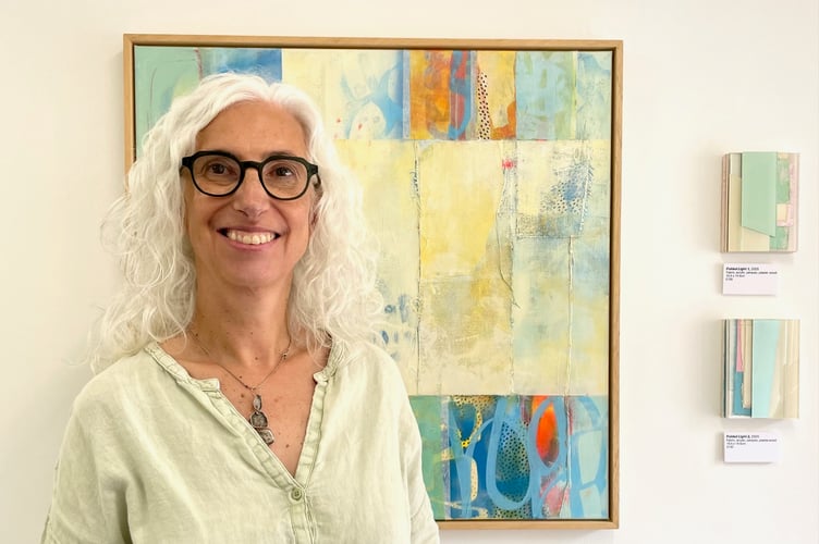 Clare Schmidt Norris standing in front of a work she made in 2021, just before she fell ill